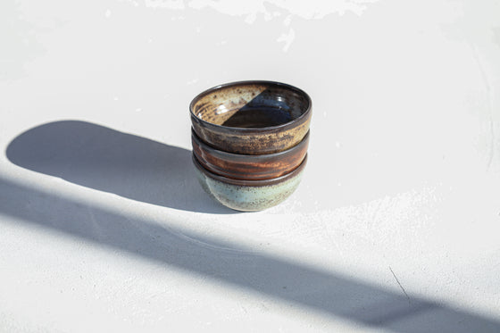 A set of 3 brown shinny bowls