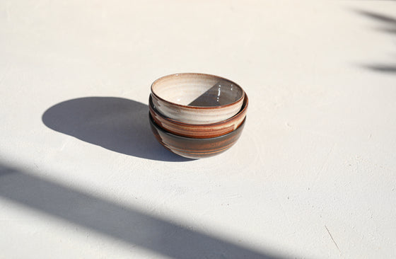 A set of 3 brown shinny bowls