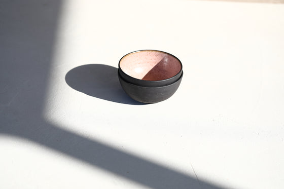 A set of 2 black pink bowls